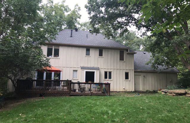 back of house with old siding