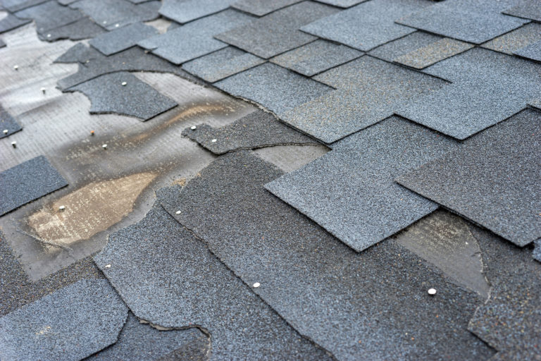 Roof with damaged and missing shingles