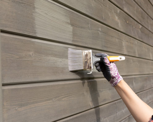 Wood siding being painted