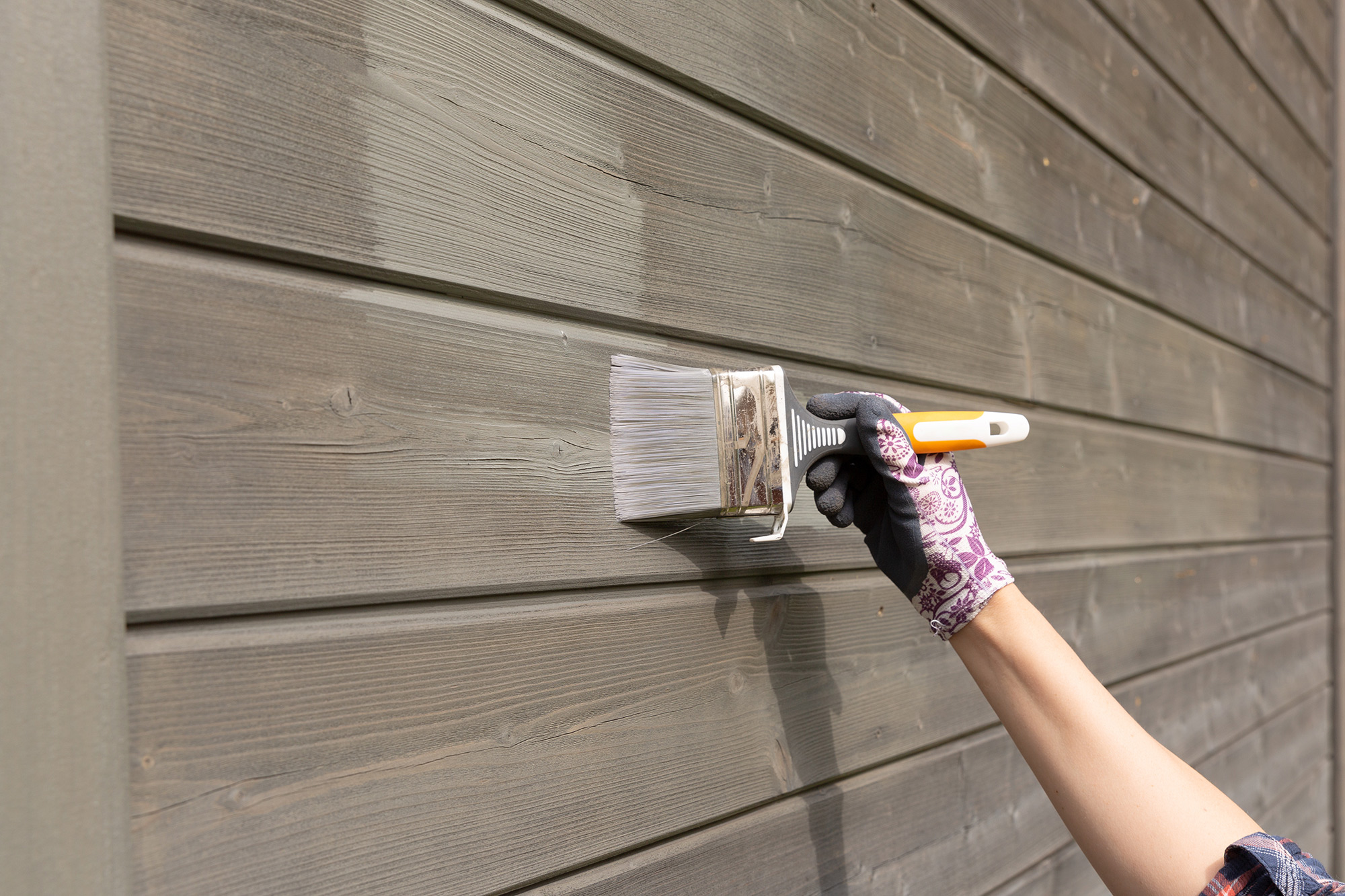 Wood siding being painted