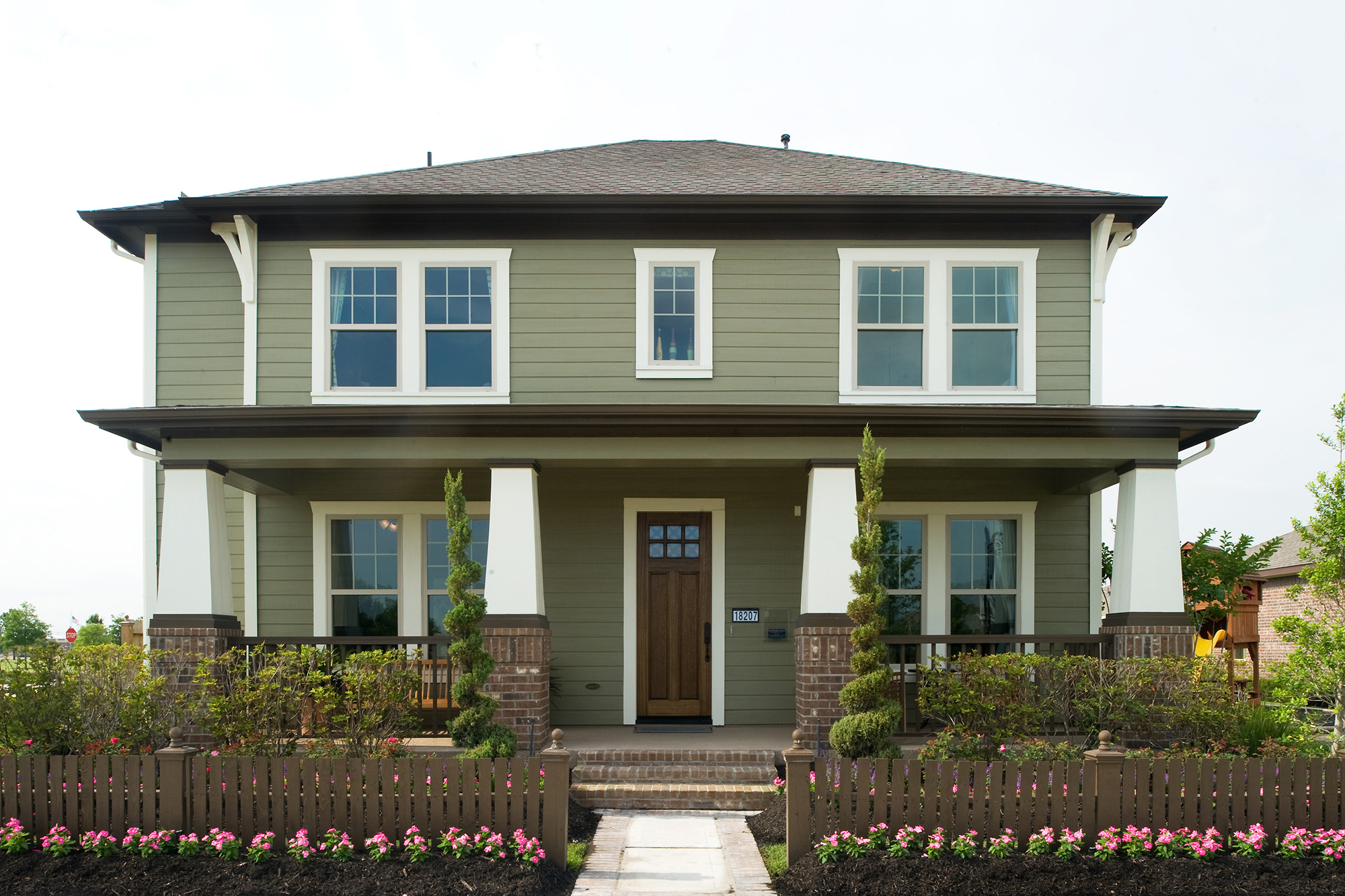 Home with olive colored lap siding installed