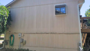 Damaged siding before client get's a siding replacement by Smart Exteriors.
