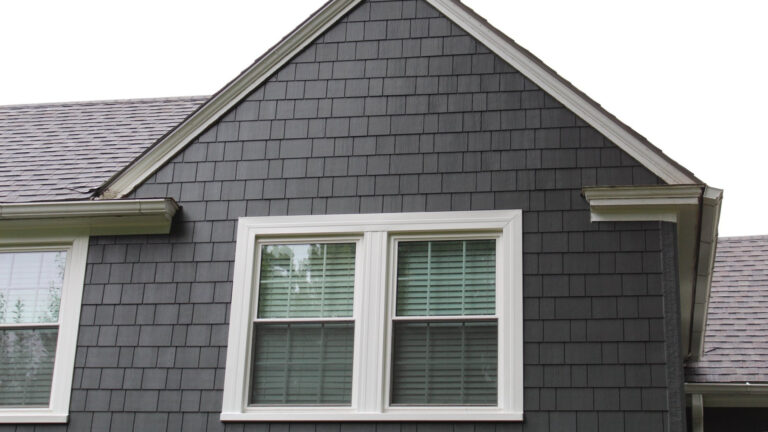 Gray shingle siding installed on a home.