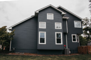 Lee's Summit Home with James Hardie Siding, ProVia Windows and Doors, and Stone Veneer Siding installed by Smart Exteriors.