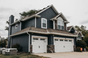 Lee's Summit Home with James Hardie Siding, ProVia Windows and Doors, and Stone Veneer Siding installed by Smart Exteriors.