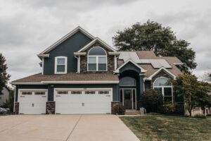 Lee's Summit Home with James Hardie Siding, ProVia Windows and Doors, and Stone Veneer Siding installed by Smart Exteriors.