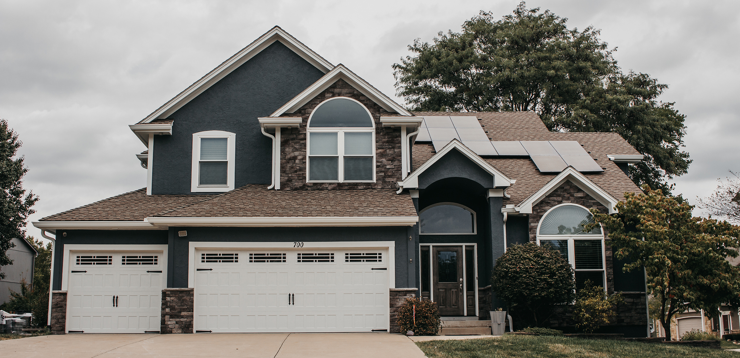 Lee's Summit Home with James Hardie Siding, ProVia Windows and Doors, and Stone Veneer Siding installed by Smart Exteriors.