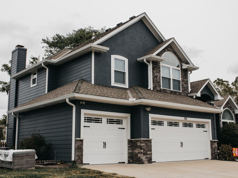 Lee's Summit Home with James Hardie Siding, ProVia Windows and Doors, and Stone Veneer Siding installed by Smart Exteriors.