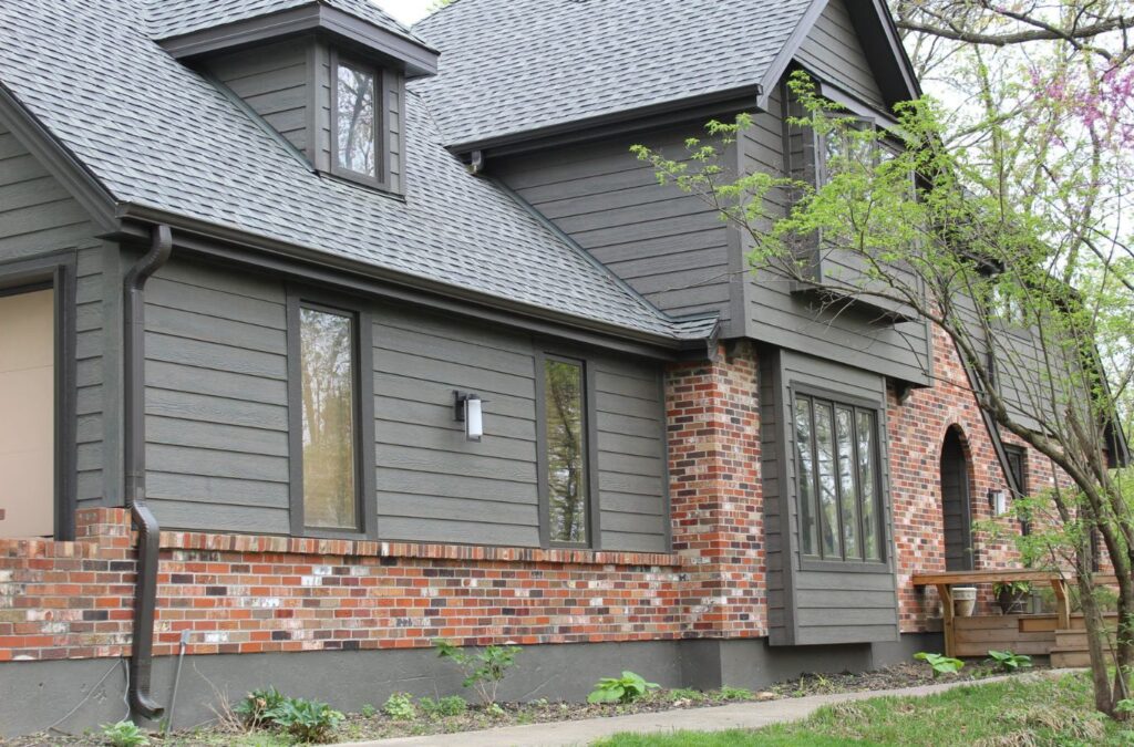 A Smart Exteriors employee providing expert siding contractor services in Belton, MO, using tools for precise and reliable siding work.